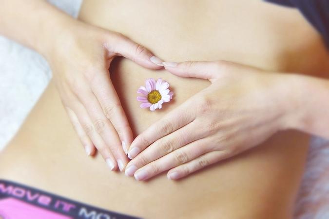 Woman with flower on abdomen