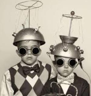 Old picture of kids with metal saucers on heads with antennas