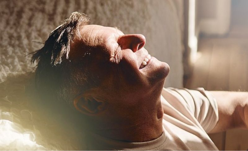 Mann som hviler og smiler