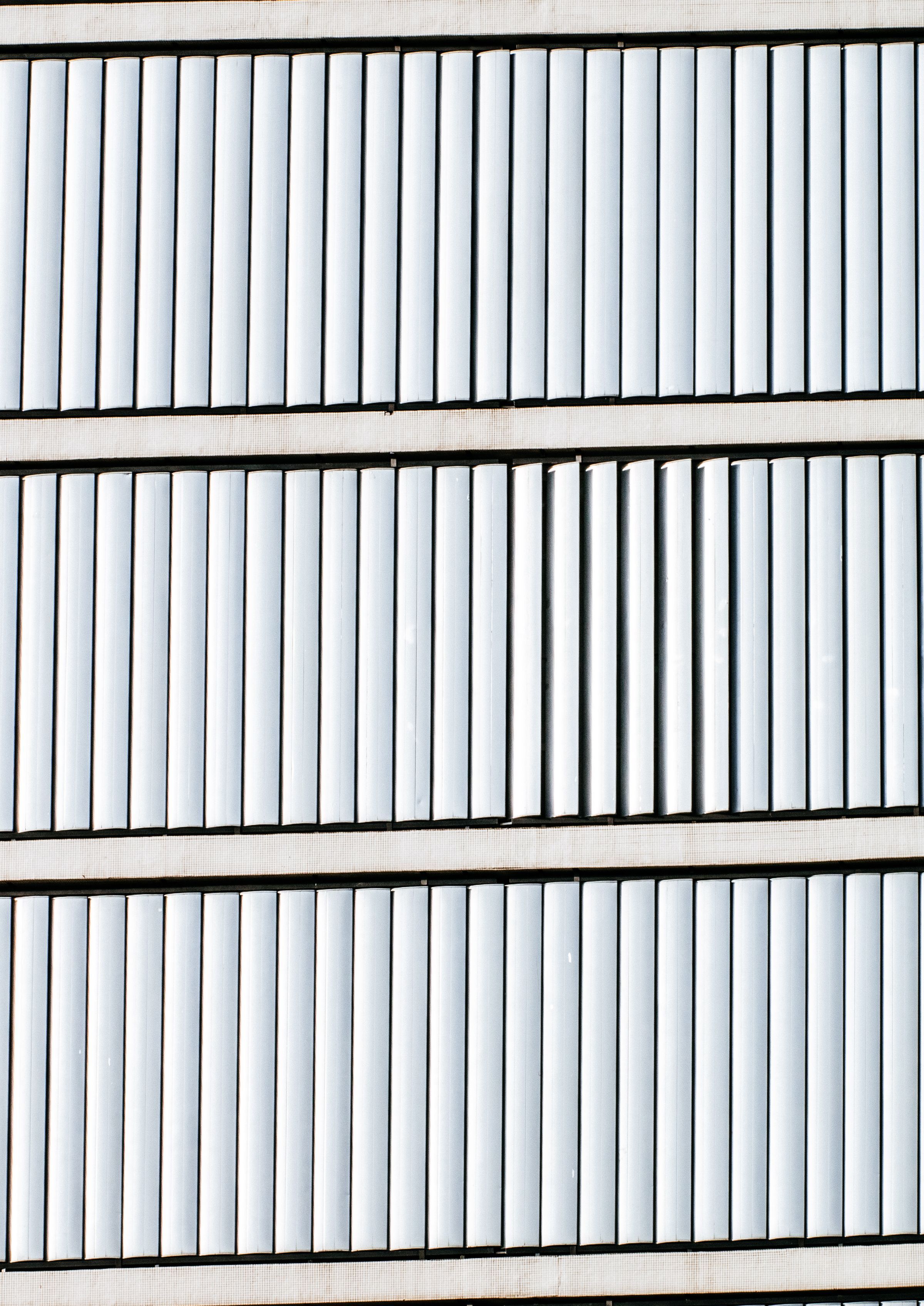 Crisp white louvred shutter panels in even architectural rhythm