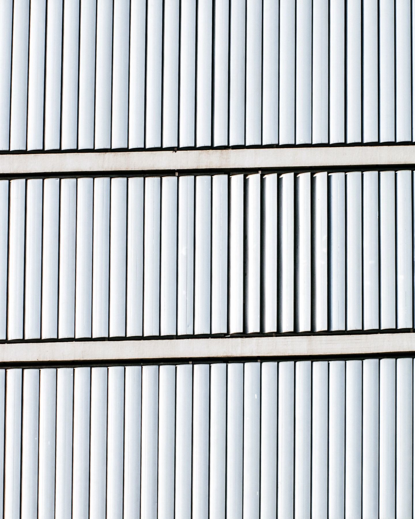 Crisp white louvred shutter panels in even architectural rhythm