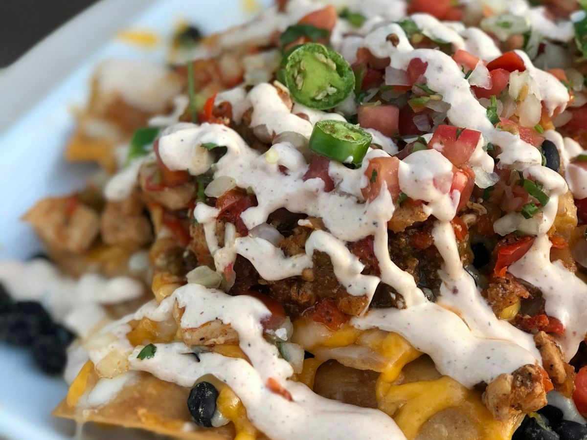Loaded Mexican nachos with cheese sauce