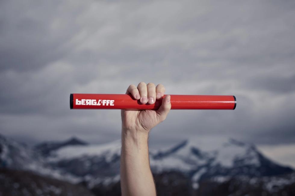 Bergaffe Pipe hold by one hand and mountains in the background