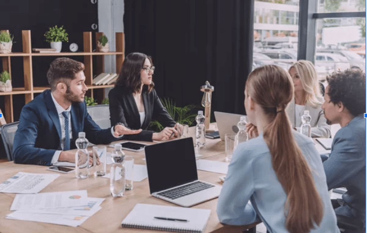 A group of 5 people having a meeting about business. [Core Principles of Branding for Local Businesses]