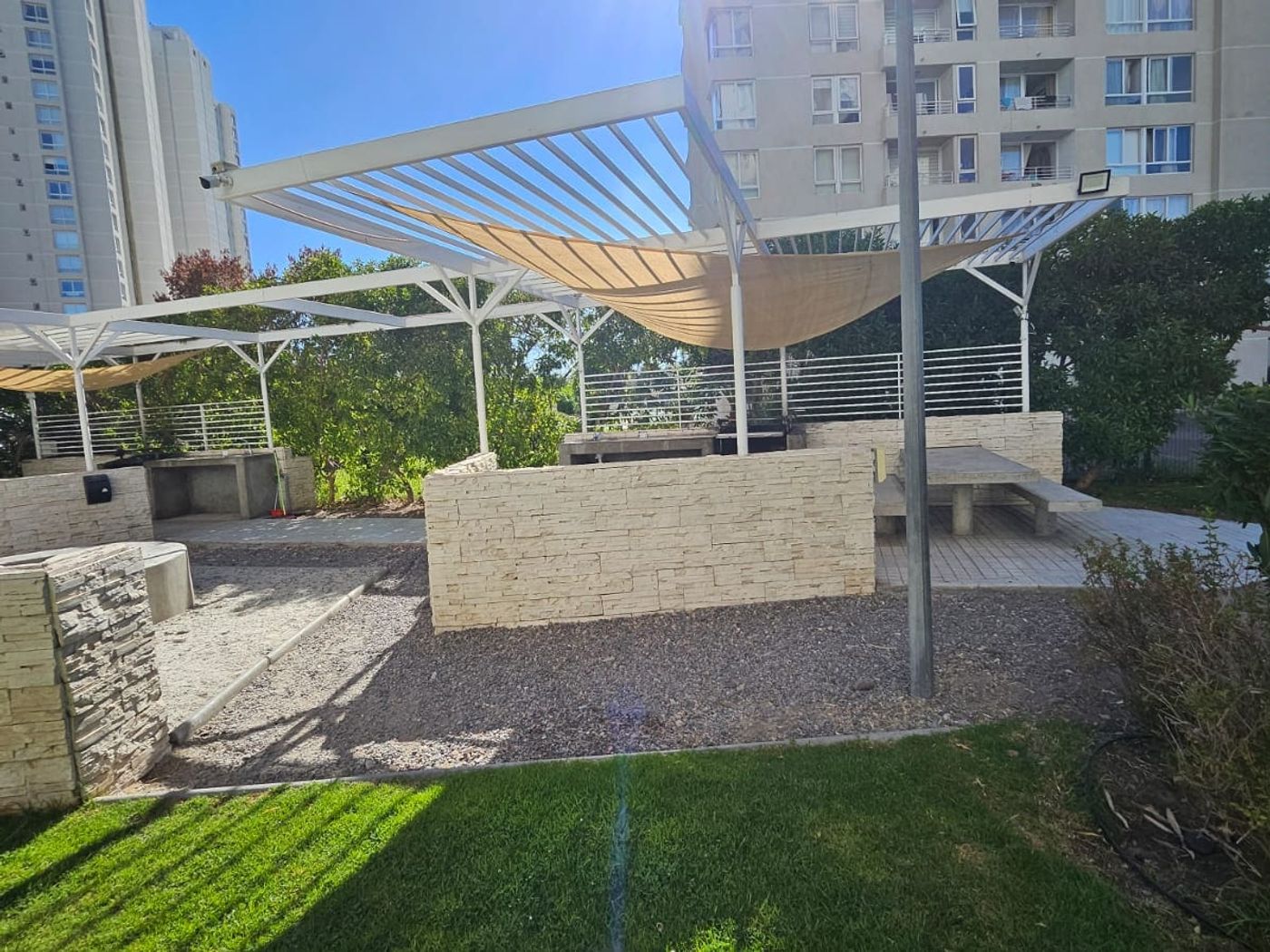 Quincho junto al jardín, bajo toldo