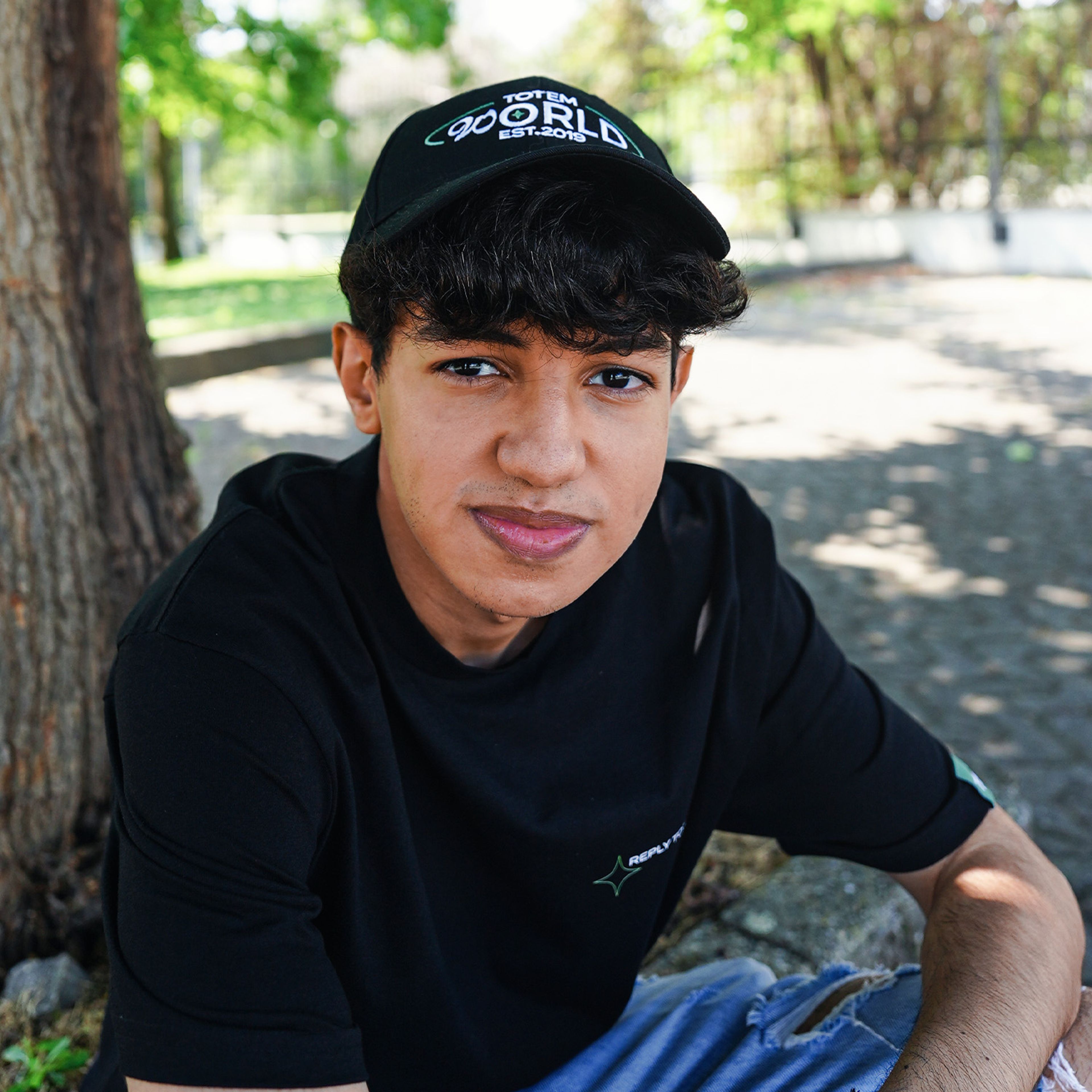 photo of Maru with the "Totem World T-Shirt" and "Totem World Hat" black edition