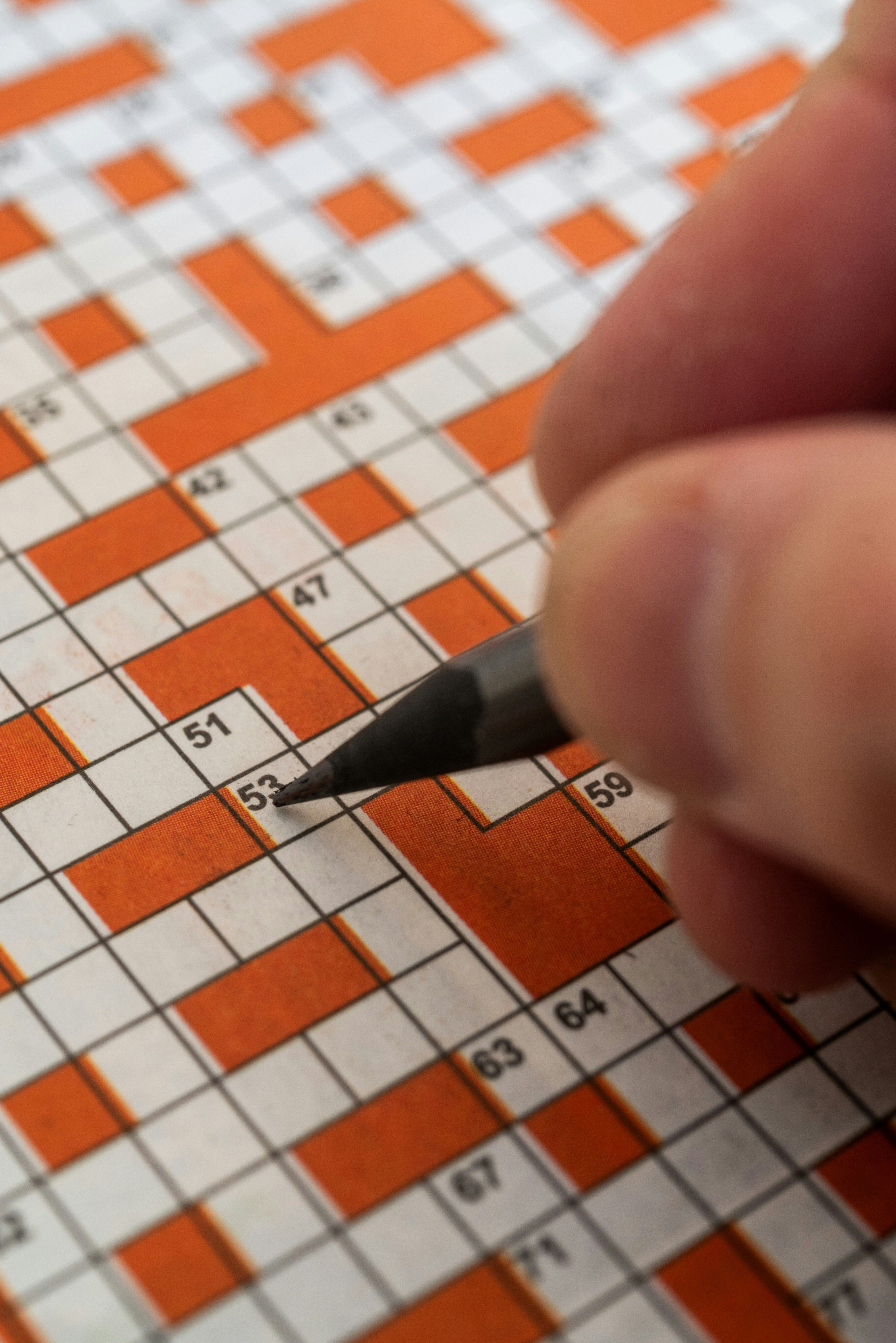 Hand filling in a crossword puzzle - Strands solver guide