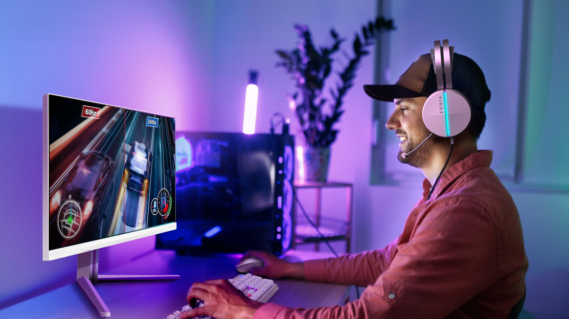 A gamer wearing a headset plays a racing game on a Philips gaming monitor in a purple and blue RGB-lit gaming setup. Copy alt text