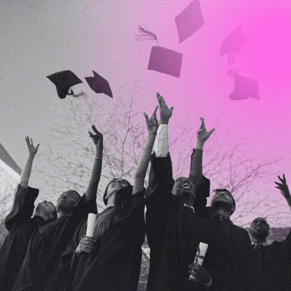 students throwing graduation caps into the air