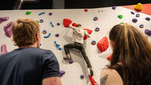 Climber being coached on the bouldering wall at The Pinnacle