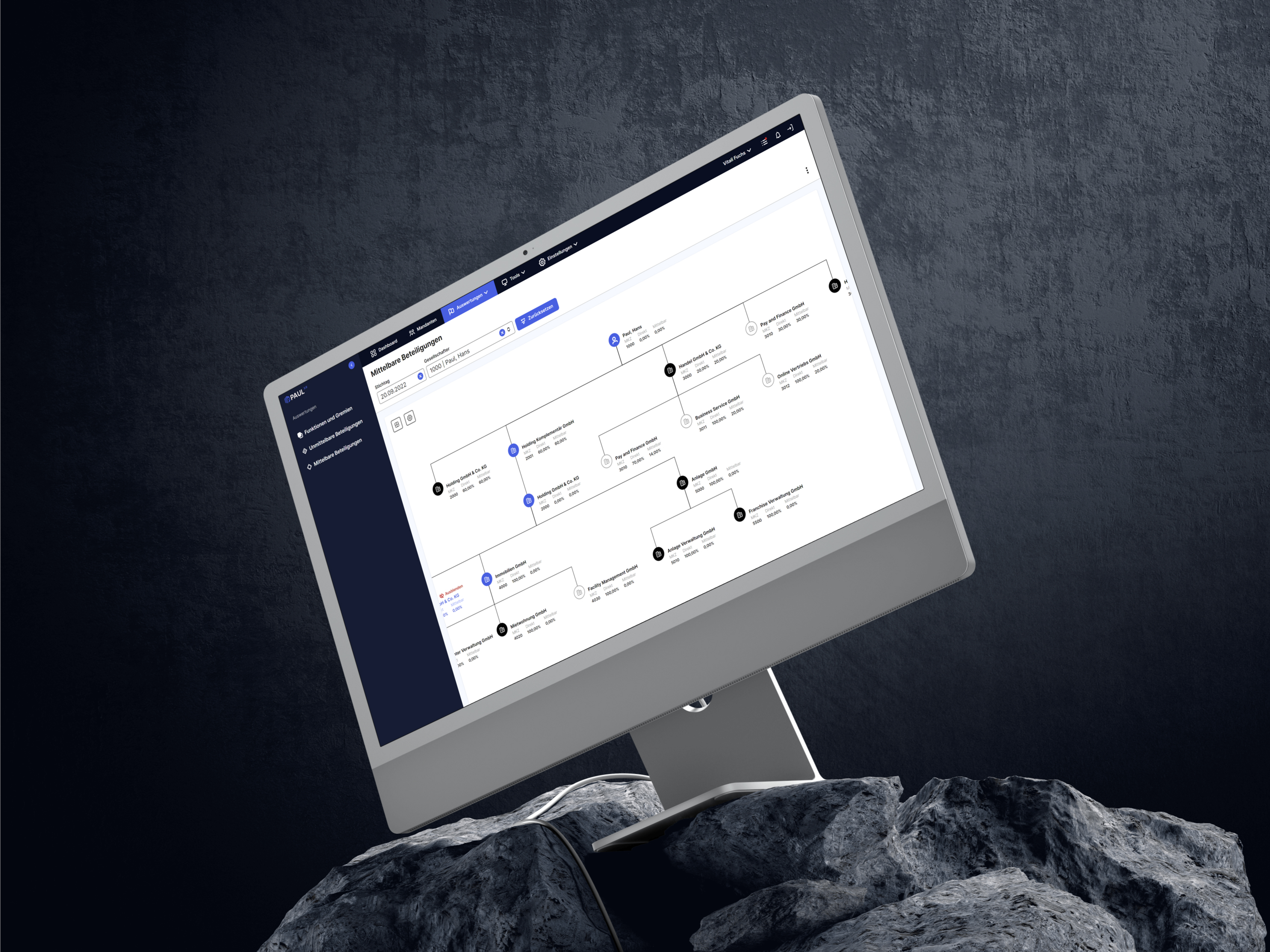 Computerbildschirm mit Diagrammoberfläche auf Felsen vor dunklem Hintergrund