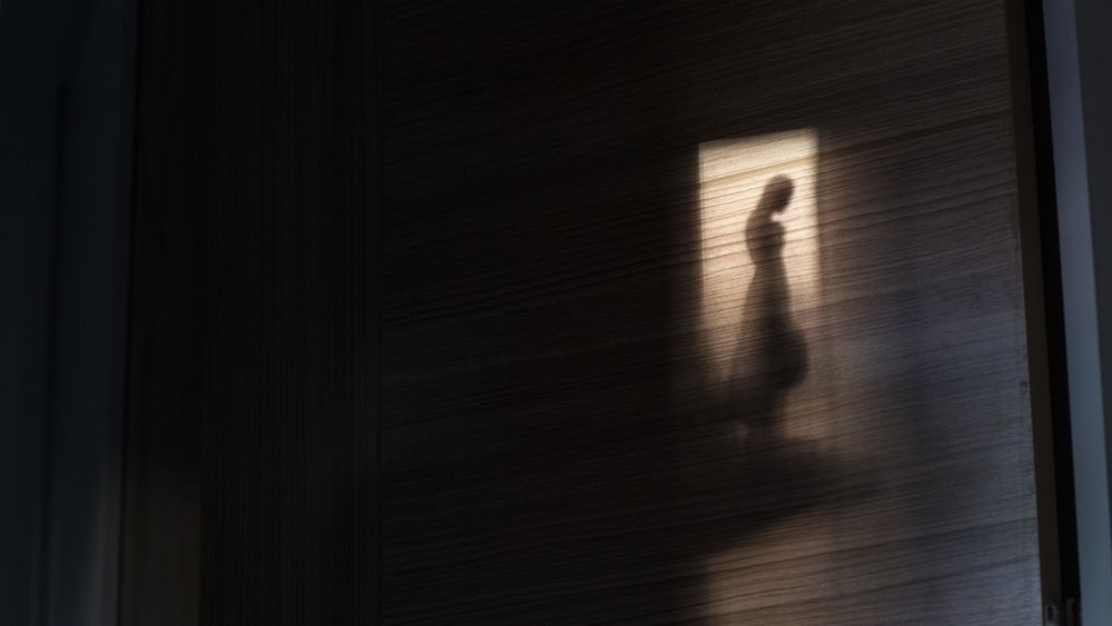 Image of a person in the shadows 