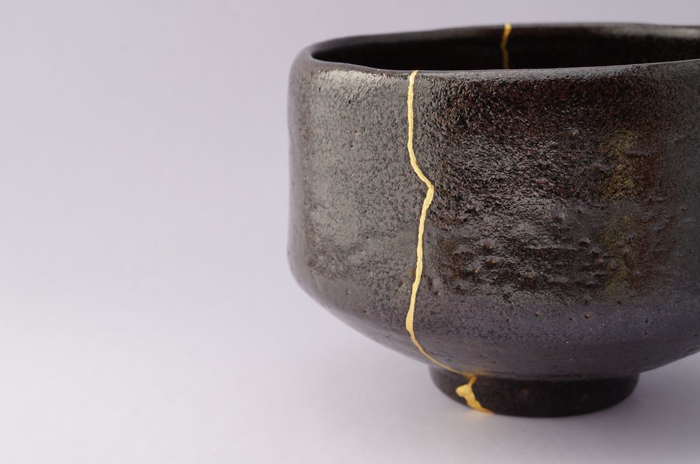 Image of a cracked pot, attached back together with gold 