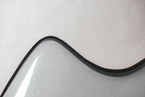 A thick black line curved on a grey background.