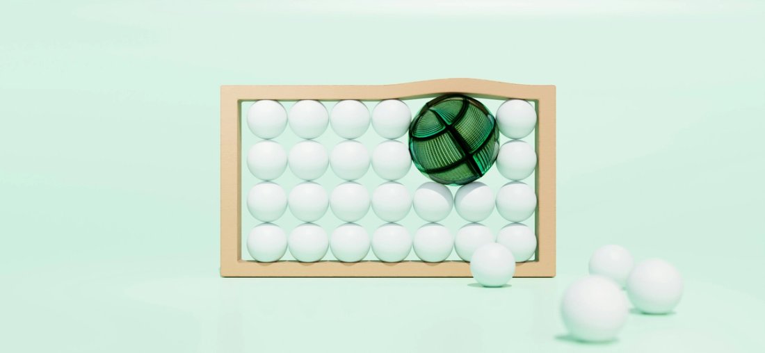 A large green sphere pushes smaller white spheres out of a tan frame.