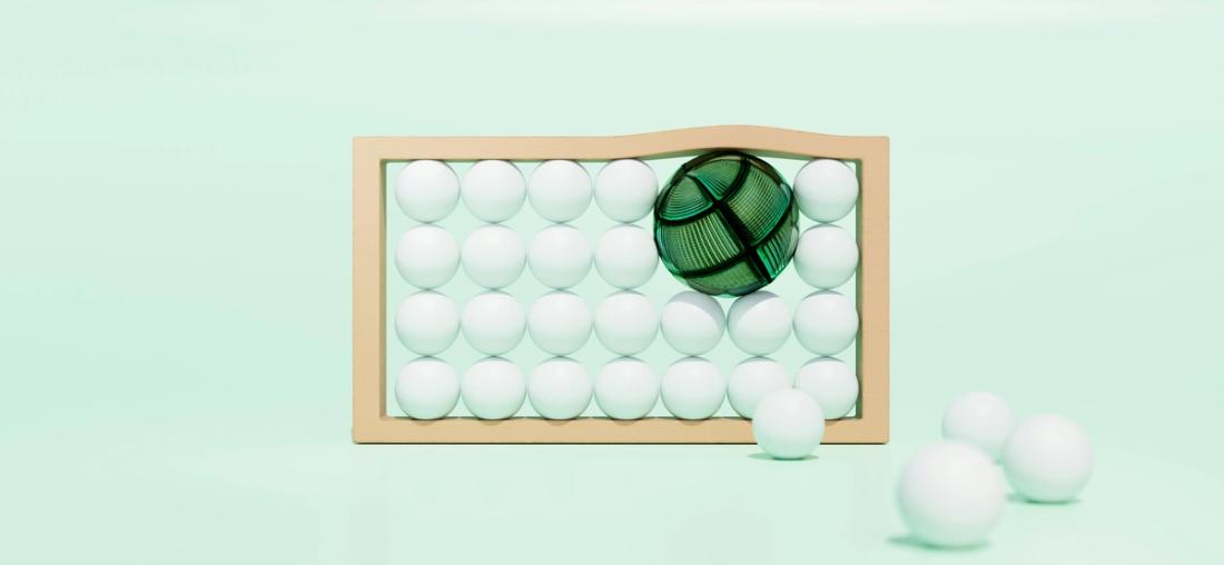 A large green sphere pushes smaller white spheres out of a tan frame.