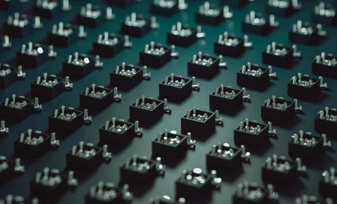 A grid of abstract boxes with metallic inserts on a dark teal background.