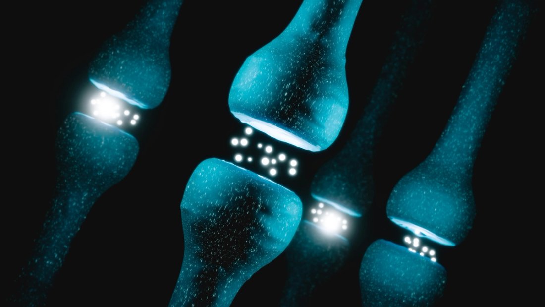 A digital rendering of teal neurons and synapses against a black background.