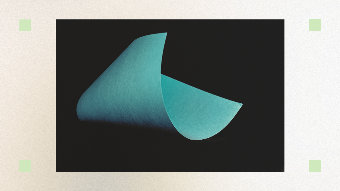 A curved teal paper on a black background.