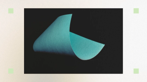 A curved teal paper on a black background.