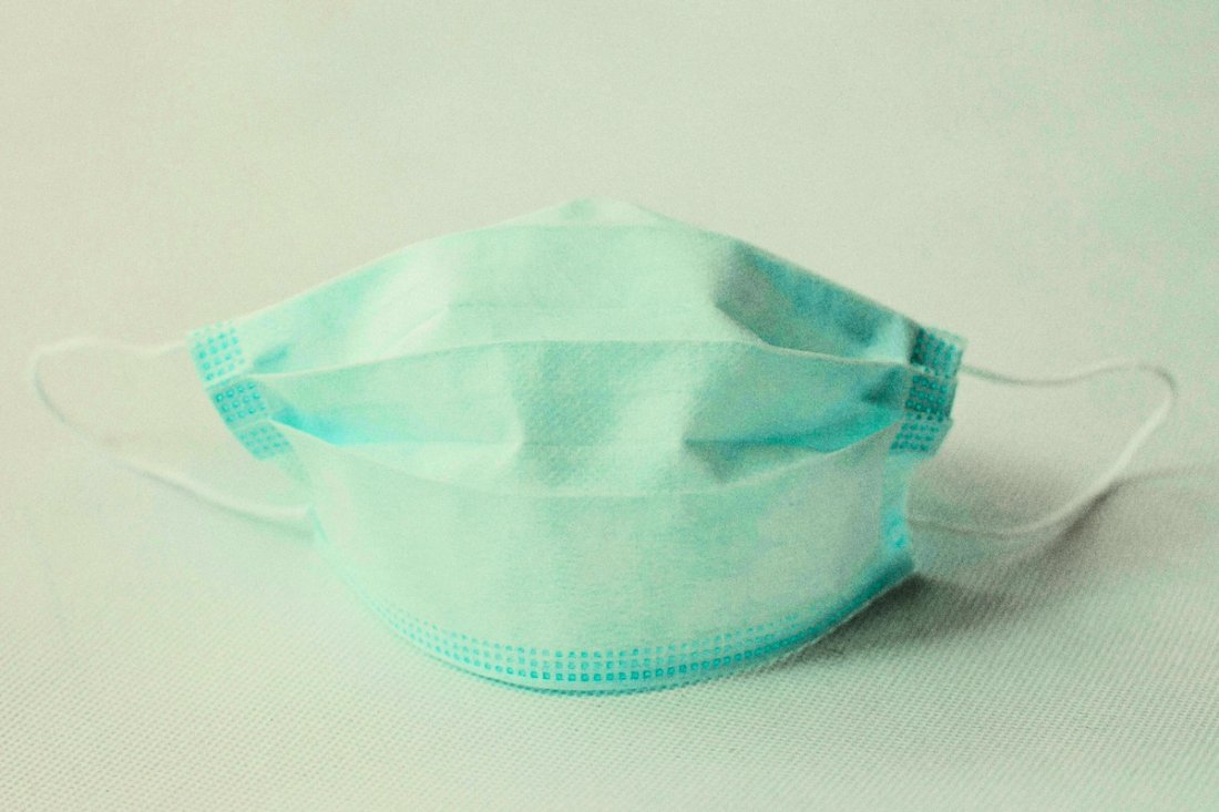 A blue face mask on a white background.