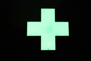 Green plus sign on a black background