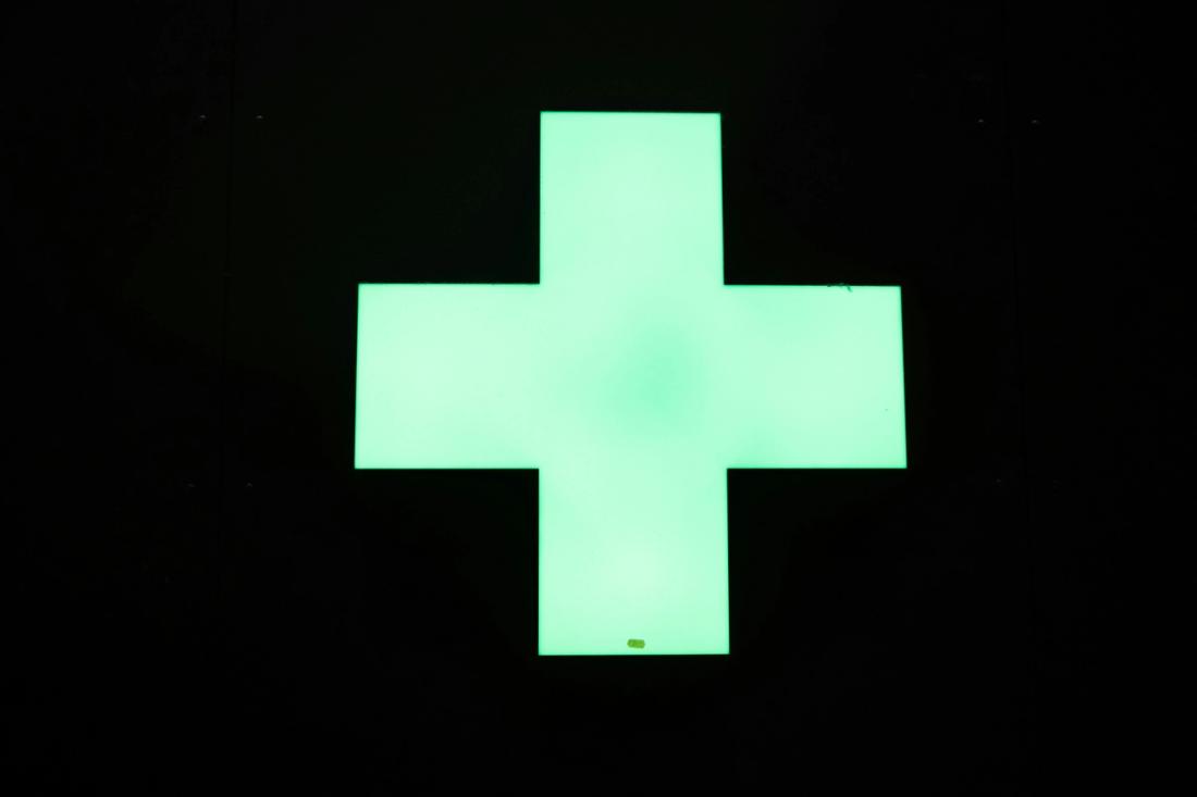 Green plus sign on a black background