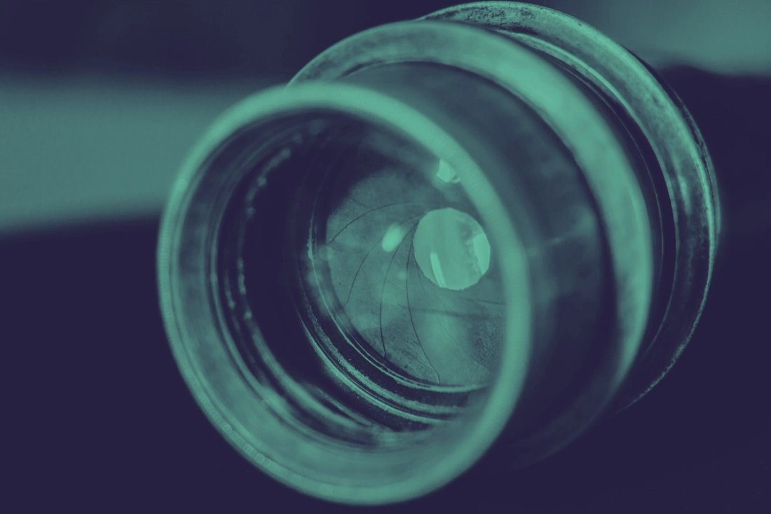 A closeup view of a green camera lens.