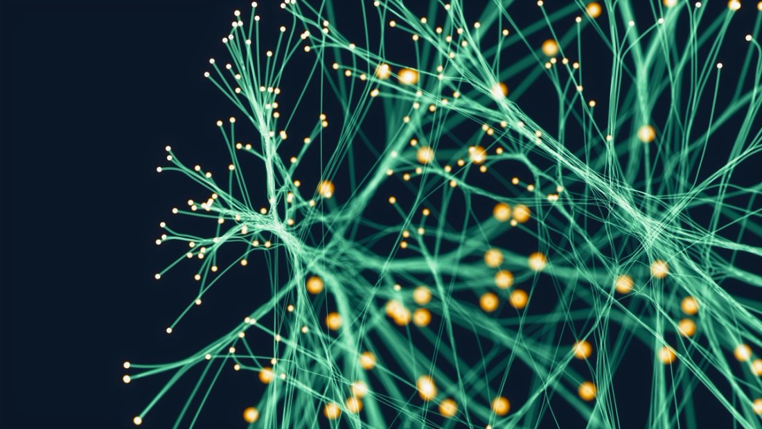 A network of green and yellow neurons against a black background.
