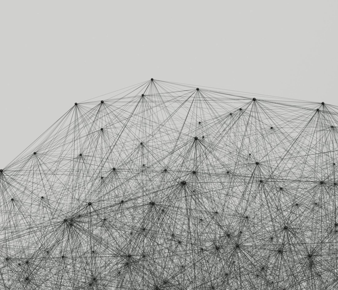 A dense network of lines and nodes on a grey background.