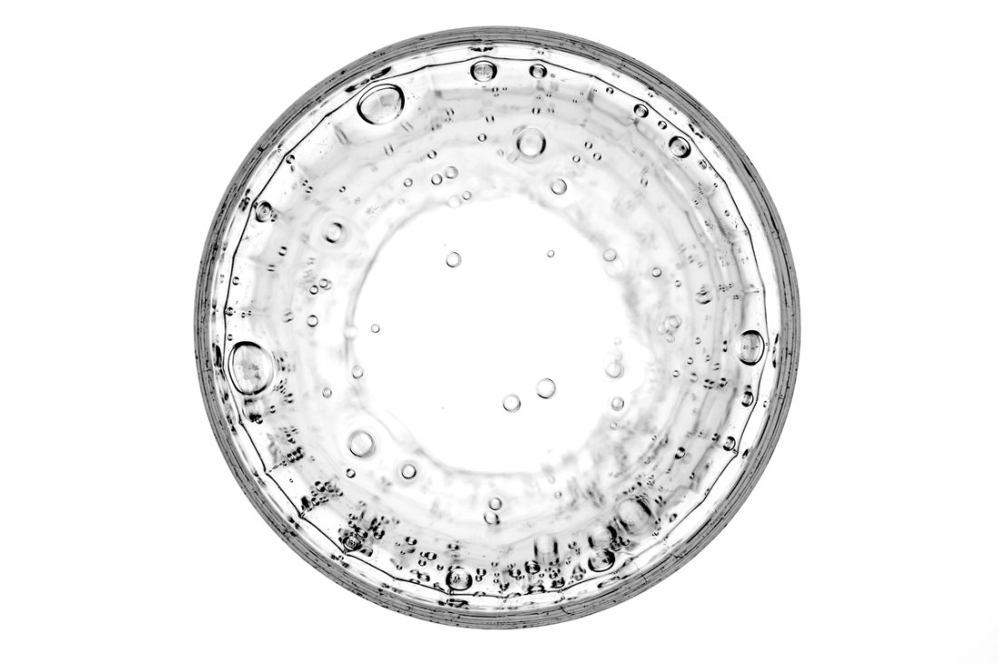 An image of grey droplets under a microscope.