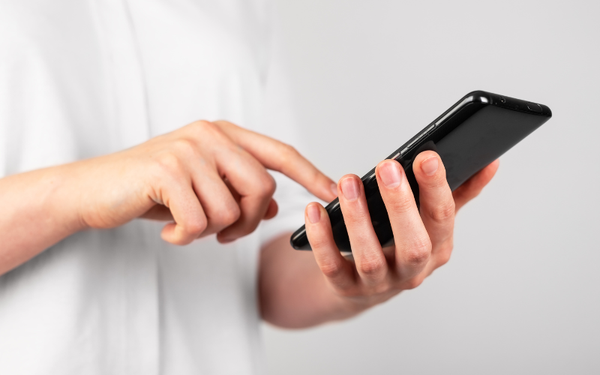 Hand holding a phone and swiping