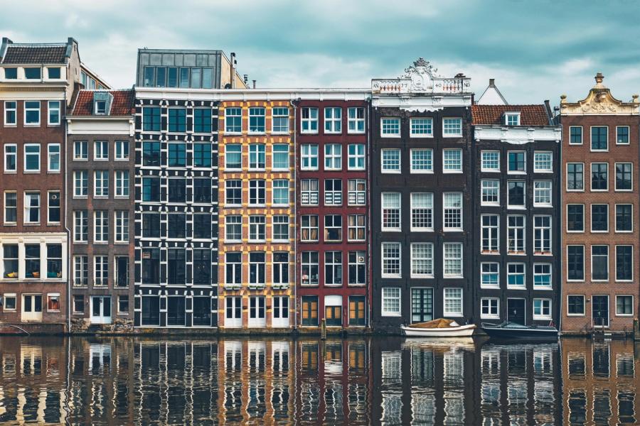 Amsterdam canal houses reflected in the Damrak waterfront