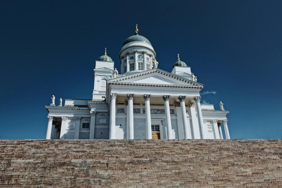 Helsinki Cathedral's white columns and green domes rise above broad stone steps