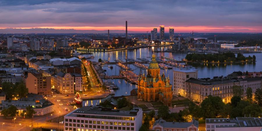 Helsinki harbor and Uspenski Cathedral illuminated at dusk