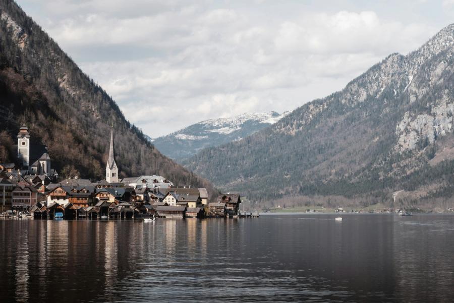 Hallstatt's church spire and waterfront houses sit below steep mountains