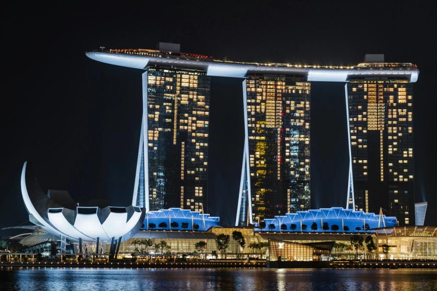 Marina Bay Sands and the ArtScience Museum illuminated beside Singapore’s waterfront