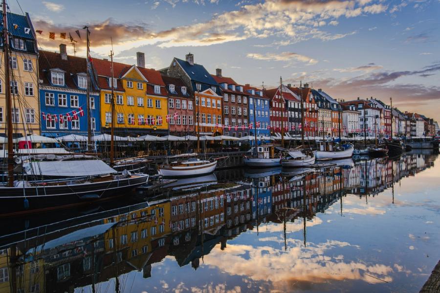 Colorful buildings and boats reflected in Nyhavn, Copenhagen