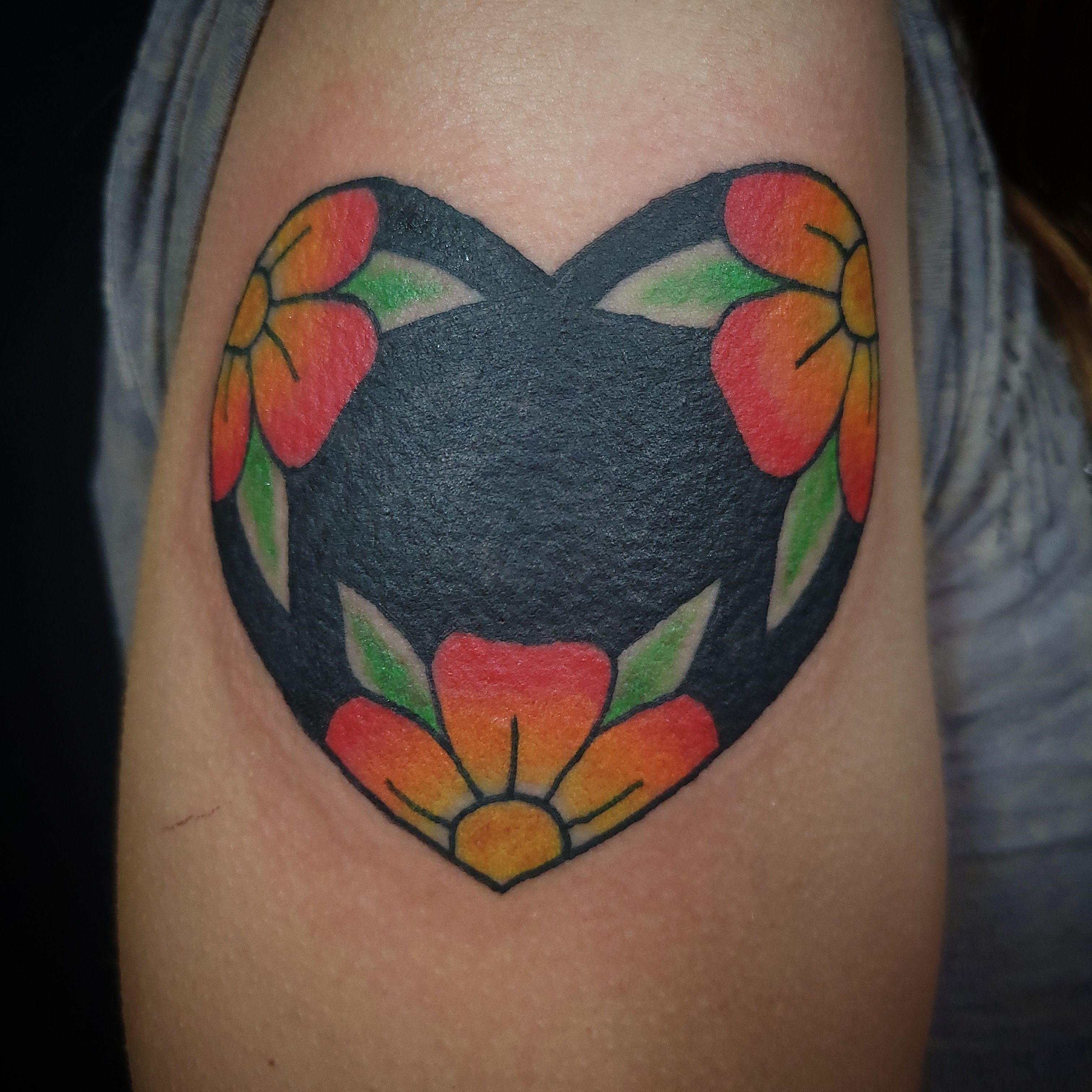 Heart tattoo with flowers inside