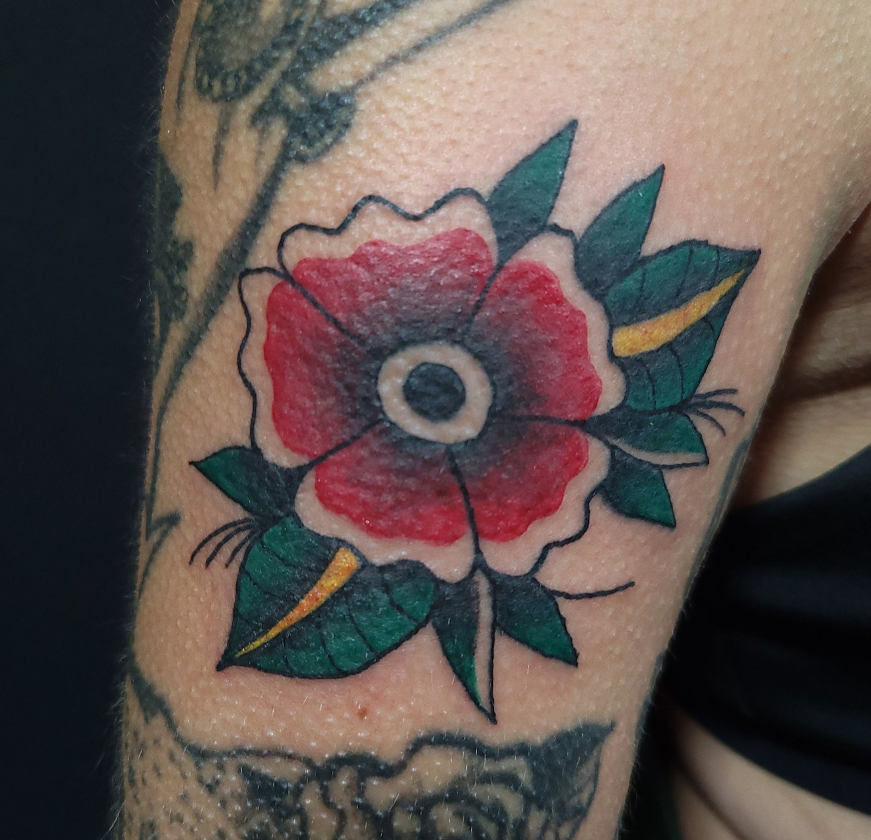 Traditional red flower tattoo