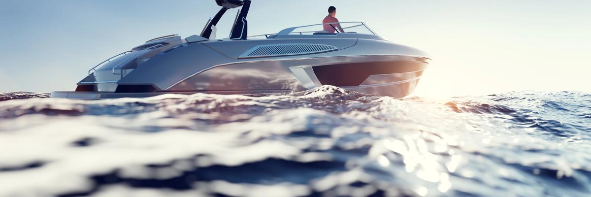 Modern wake boat cruising across a lake at sunset during Utah boating season.