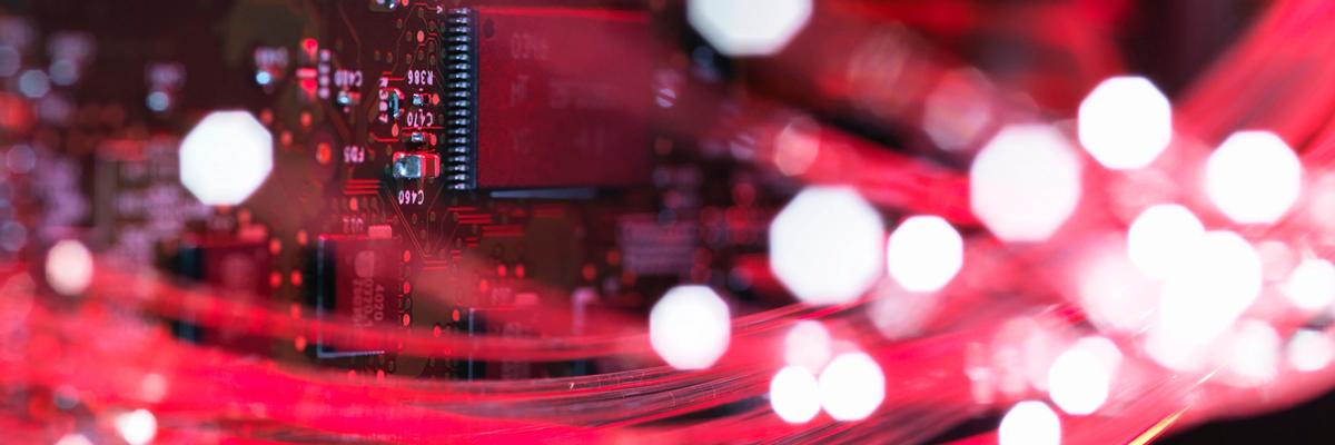 Close-up of fiber optic cables transmitting data across a circuit board, representing Utah’s growing technology and digital infrastructure sector.