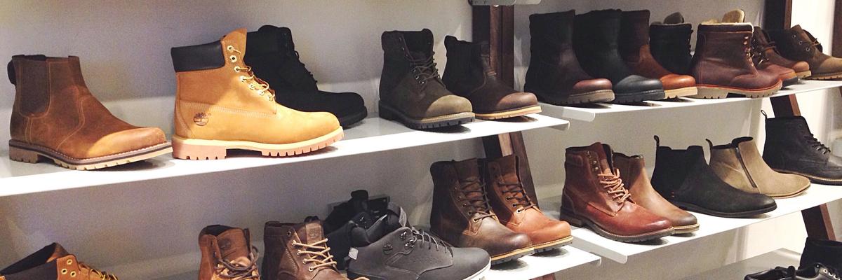 Display of boots and shoes on shelves inside a footwear store in Utah.