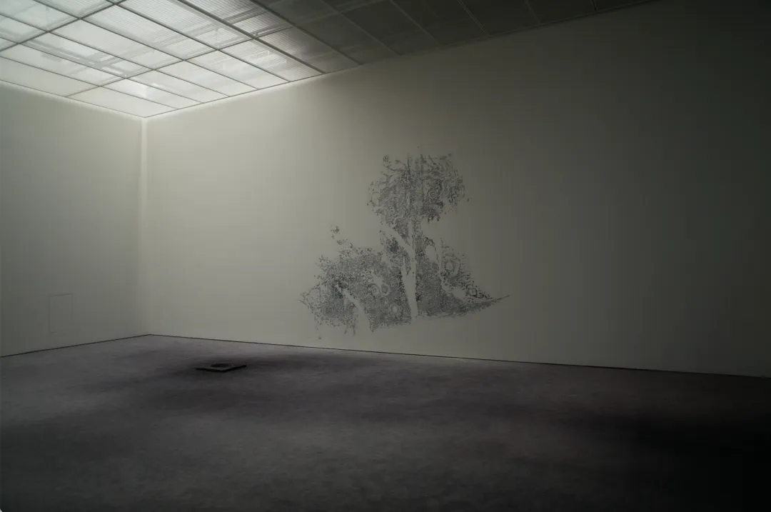 Layers of paint from past exhibitions exposed by sanding the wall in Timekeeper