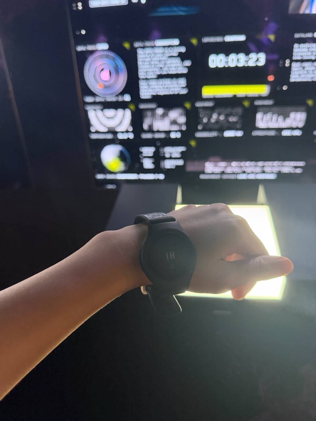 Visitor putting on a biometric wristband at Dataland’s entrance