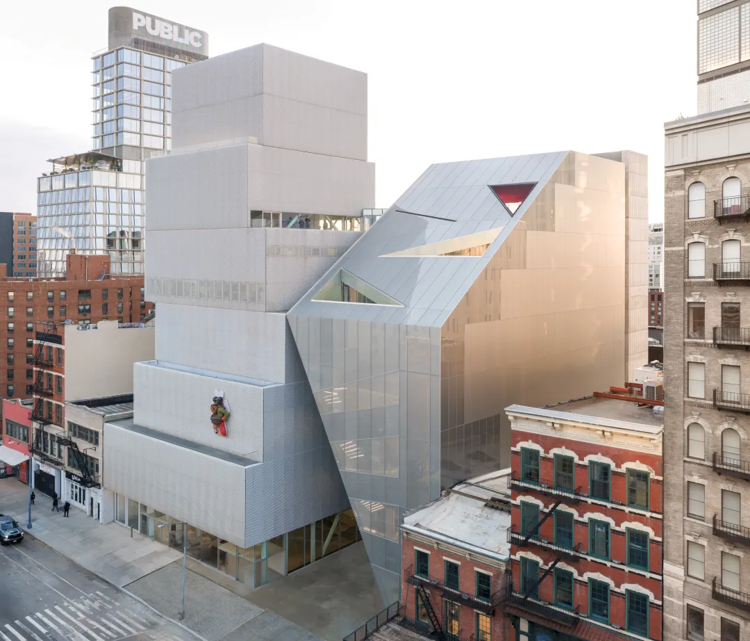 OMA’s new wing and SANAA’s existing building stand side by side at the New Museum: one stacks vertically, while the other opens toward the street, 2026.
