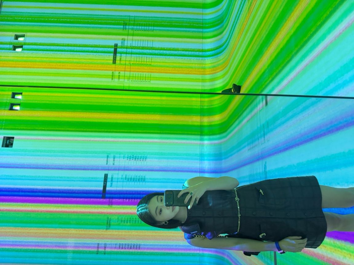Visitor surrounded by projected imagery at Dataland