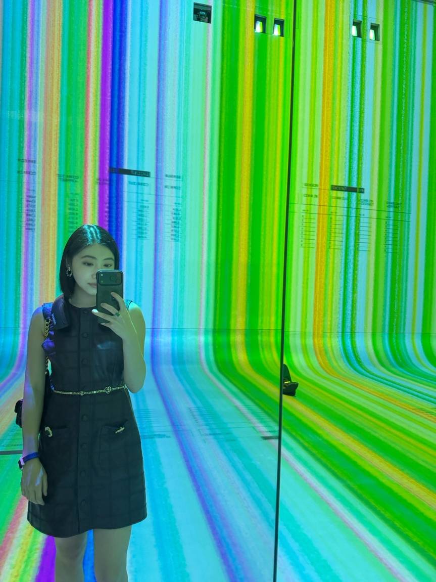 Visitor surrounded by projected imagery at Dataland