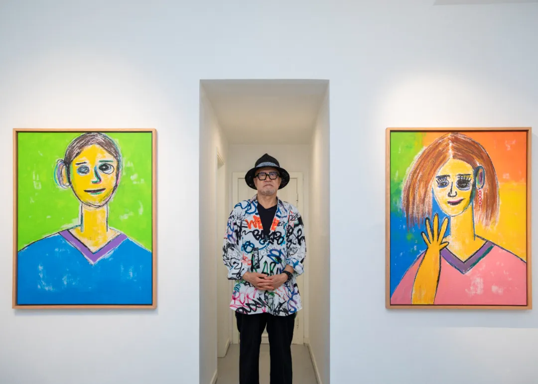 Kim Chang-il with his portrait paintings