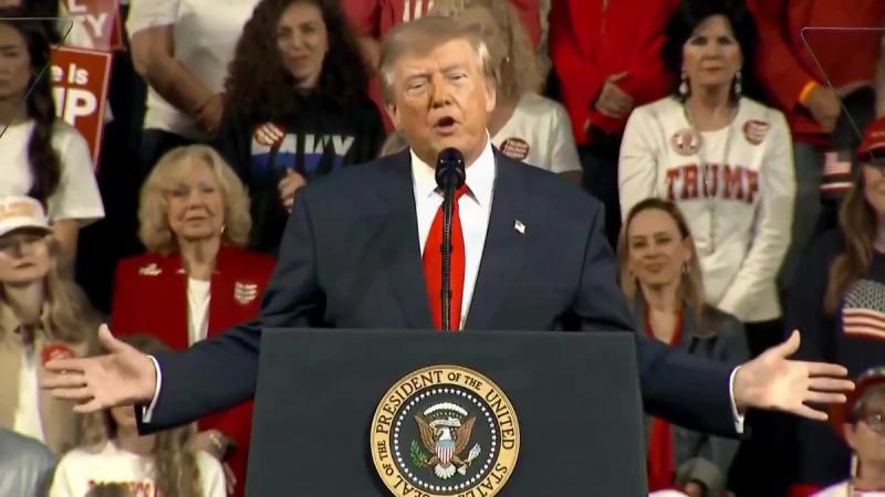 President Trump speaks at the presidential lectern with arms outstretched as supporters stand behind him at his rally in Tennessee, October 10, 2026 (still from Official White House video)